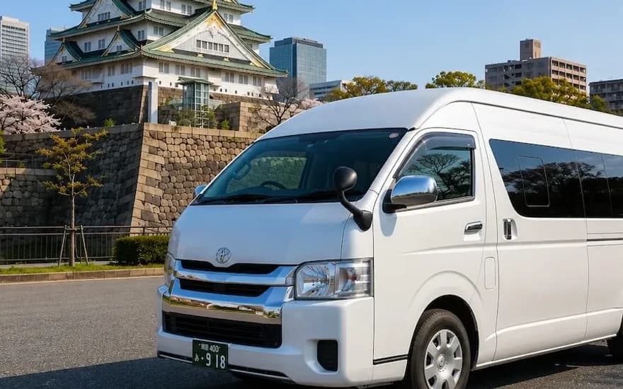 White Toyota Hiace van for group travel in front of Osaka Castle, Japan